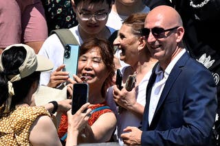 Cagdas Halicilar poses for photos with tourists